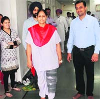 Patient Harinder Kaur, who underwent a knee replacement surgery, walks with Dr Ashish Sheth in Bathinda. Tribune photo