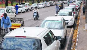 Vehicles parked on the roadside due to non-availability of proper space on the PU campus. 