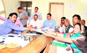 Seeking partys support: Samajwadi Party candidate Anita Saini submits her nomination papers in Haridwar on Thursday