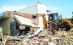 A structure is demolished by MC officials in Kaithal on Wednesday