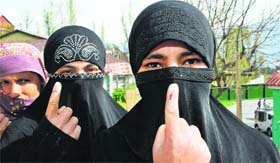 Nayaz Neen, a 20-year-old student, shows her inked-marked finger after casting her vote at Batote in Ramban district on Thursday.