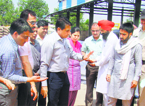 DC Balraj Singh talks to farmers at Karnal grain market on Friday.