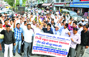 Members of the Abhibhavak Ekta Sangh shout slogans against private schools demanding, withdrawal of the fee hike at Committee Chowk in Karnal on Friday.