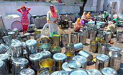 Workers wash utensils that store mid-day meals in Jalandhar