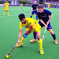 Manpreet Singh (in yellow) in action on Friday