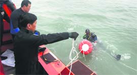Rescuers search for the missing at the sea off Jindo.