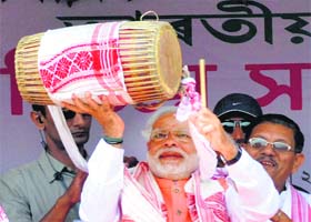 Narendra Modi plays traditional Assamese dhol during a rally at Mongoldoi, Assam, on Saturday