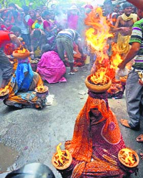 Devotees perform rituals during Sheetla Puja in Kolkata on Saturday