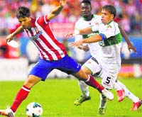 Atletico Madrids Diego Ribas battles for the ball with Elche's Rivera during their La Liga match in Madrid on Friday. AP/PTI