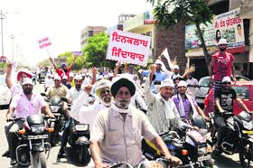 Out on streets: AAP workers during a road show in Bathinda on Sunday