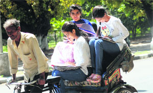 College students make a final revision on the way to take their examination at Panjab University in Chandigarh.