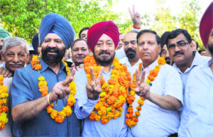 (From left) General secretary JS Gogia, chairman Baljinder Singh Bittu and vice-chairman JC Verma celebrate their victory in the FOSWAC elections at the Community Centre, Sector 27, in Chandigarh on Sunday. 