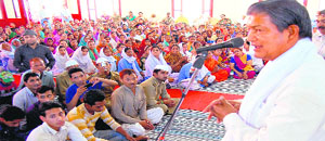 WOOING VOTERS: Chief Minister Harish Rawat addresses a public meeting at the Nirankari ashram in Haridwar on Sunday.