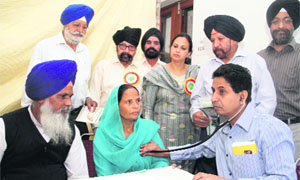 A doctor examines a woman at a free heart check-up camp in Dehradun on Sunday. 