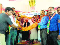 BJP candidate Shanta Kumar, along with JP Nadda, BJP national general secretary, being garlanded at an election rally at Fatehpur in Kangra on Sunday.