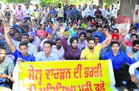 Candidates, who cleared the physical fitness test for the post of jail warden, hold a protest against the delay in issuing the merit list in Jalandhar on Sunday