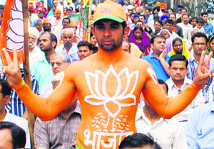 A BJP supporter makes a victory sign during a rally in Amritsar on Monday.