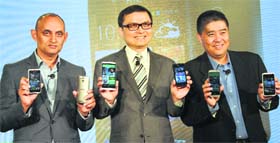 HTC India country manager Faisal Siddiqui (L), president of global sales and CFO Chia-Lin Chang and HTC South Asia president Jack Yang (R) pose with newly launched mobile phones in New Delhi on Monday.