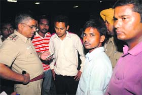 A file photo of a police official checking the mobile phone of the victim, Pushkar Singh, at the GMCH, Sector 32, Chandigarh
