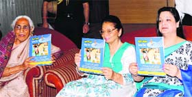 First Lady Usha Vohra releases a souvenir of the Vasudhaiva Kutumbakam Welfare Society at a function in Jammu on Monday