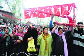 In support: National Conference supporters hold a plough, party symbol, during a campaign rally at Chadoora district in Budgam on Monday
