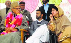 NC president Farooq Abdullah having a word with party leader Shehnaz Ganai during a rally in Budgam district on Monday