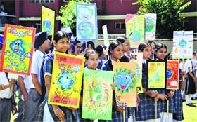 Students hold placards during the Earth Day celebrations at GGN Public School, Rose Garden, in Ludhiana.