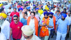 SAD-BJP candidate Manpreet Singh Ayali (garlanded) campaigns in Ludhiana on Monday.