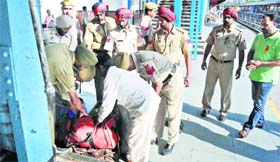Policemen check a visitors luggage railway station in Ludhiana on Monday.