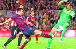 Barcelonas Lionel Messi tries to score against Athletic Bilbao during their La Liga match in Barcelona on Sunday. Reuters