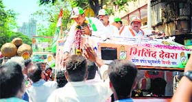 Congress candidate Milind Deora greets supporters during a road show in Mumbai.