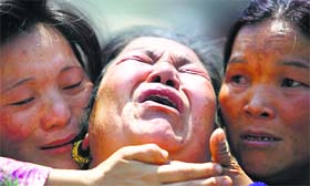 A family member of a Sherpa climber is comforted by relatives during a funeral in Kathmandu on Monday.
