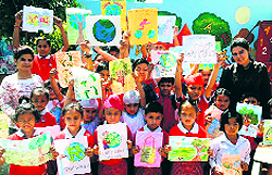 Children with posters made on the theme of Earth Day in Amritsar on Tuesday