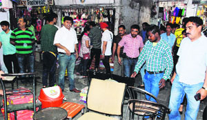 MC enforcement wing officials confiscate goods at Shastri Market in Sector 22 during an anti-encroachment drive in Chandigarh on Tuesday.