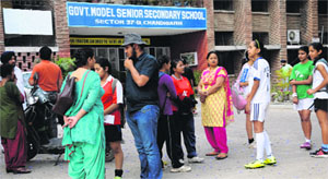 Parents await the announcement of the status of city teams participation in the football nationals, at Government Model Senior Secondary School, Sector 37, Chandigarh, on Tuesday.