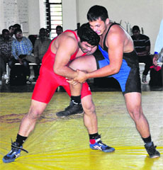 Ankit (left) and Mohit slug it out during the state wrestling championship at the Sports Complex in Sector 42, Chandigarh, on Tuesday.