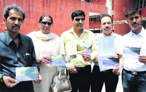 Members of the Residents Welfare Association, Sector 45-C, at the MC office on Tuesday.