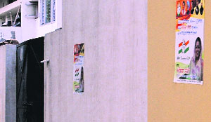Posters displayed on the wall of a house at Phase I in Mohali without the mandatory information.