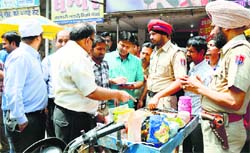 Officials of the Health Department challan a violator in Ludhiana. Photo: Inderjeet Verma