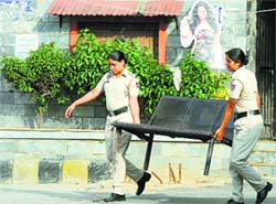 Women cops carry a bench installed at the MC park in Sarabha Nagar Market, Ludhiana. Tribune photo: Himanshu Mahajan