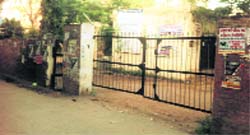 Posters dot the boundary wall of a government office in Mandi Ahmedgarh. A Tribune photograph