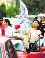 A girl holds a banner motivating people to vote during a vintage car rally in Ludhiana on Tuesday. Tribune photo: Himanshu Mahajan