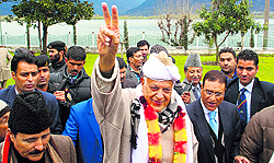 Union minister and NC patron Farooq Abdullah flashes a victory sign after filing his nomination papers at Dargah Hazratbal in Srinagar