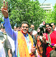Congress MP Sanjay Nirupam and (right) BJP leader Gopal Shetty greet supporters after filing their nomination papers from the North Mumbai constituency