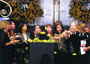 Women blow yellow rose petals over an urn containing the ashes of late Colombian Nobel laureate Gabriel Marquez during a public viewing in Mexico City on Monday.