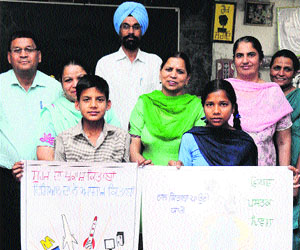 Yaadpreet Singh and Lovleen Kaur pose after their selection for the state-level poster-making competition in Bathinda on Wednesday.
