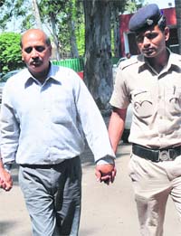 Bal Niketan supervisor Manish Arora being taken to the GMSH, Sector 16, for a medical examination on Wednesday. 