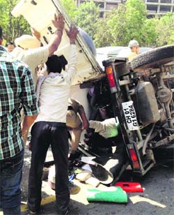 Passersby rescue the injured on the road separating Sectors 16 and17 in Chandigarh. 