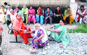 Women visitors wait outside the new building of the MC in Sector 14, Panchkula, on Wednesday.