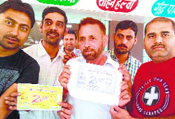The winner of Rs 1 crore prize money, Subhash Sharma (centre), with friends in Abohar.